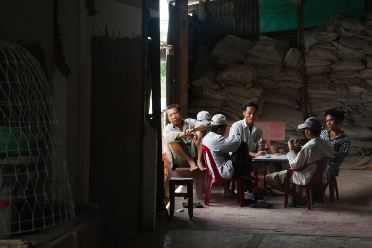 Men playing cards in the Mekong Delta, Vietnam